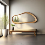 May include: A light wood bench with a beige cushion sits in front of a large, organic-shaped wooden mirror. A potted plant sits on the floor next to the bench.