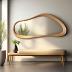 May include: A wooden bench with a light beige cushion and a large, organic-shaped wooden mirror with a reflective surface hanging on the wall behind it.