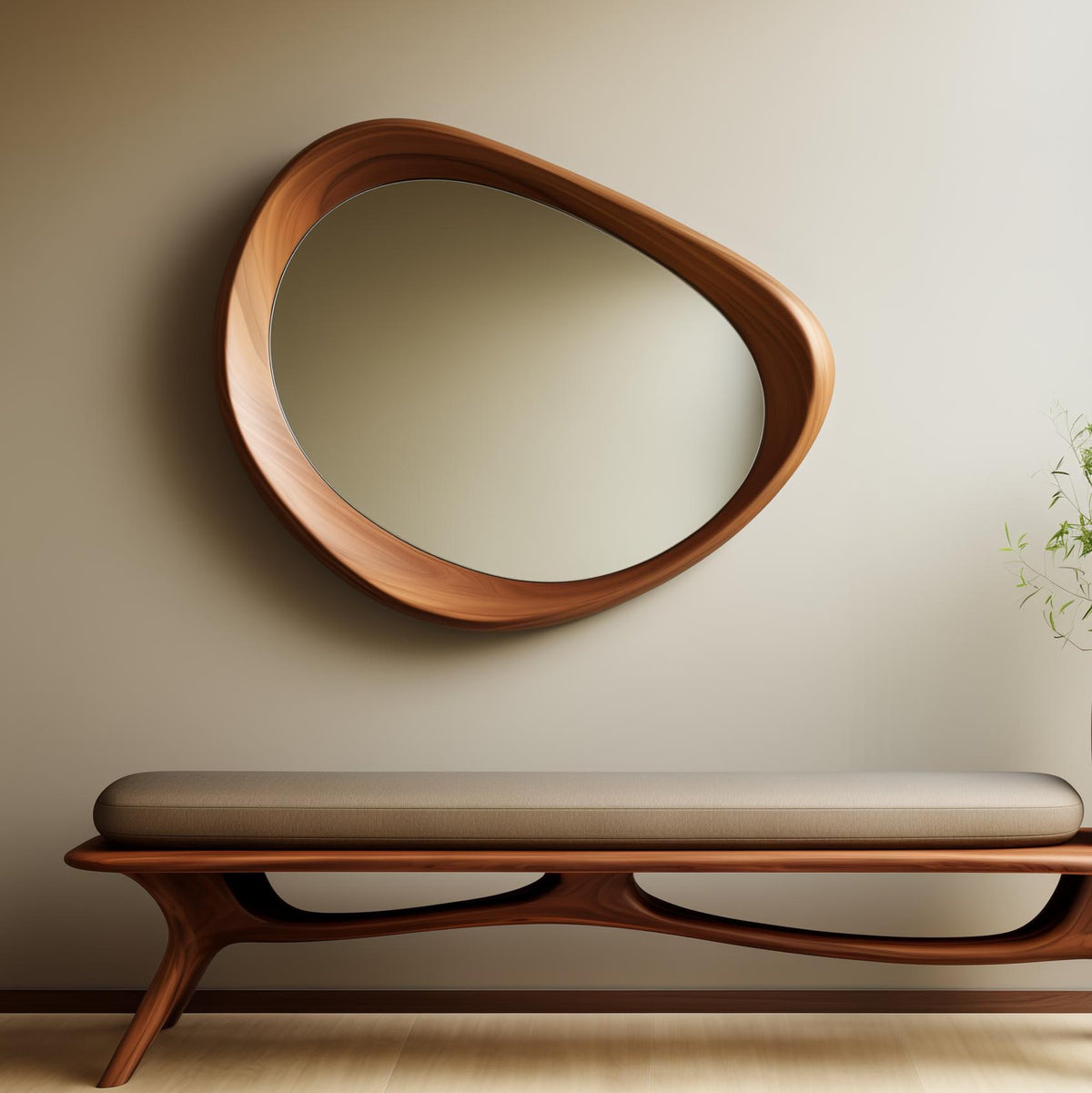 May include: A modern, oval-shaped wooden mirror with a natural wood grain finish hangs above a bench. The bench has a brown cushion and a matching wooden frame with a unique, curved design. The wall is a neutral beige color.