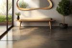 May include: A minimalist interior scene featuring a wooden bench with a light-colored cushion, a curved wooden mirror, and a potted plant. The room has a polished concrete floor and a large window with a view of greenery.
