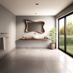 May include: A modern bathroom with a large, uniquely shaped wooden mirror. A wooden shelf holds a white sink, toiletries, and bottles. A potted plant sits beside a large window overlooking a green lawn. The floor is tiled.