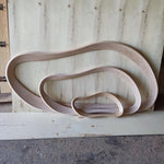 May include: Three unfinished wooden, organically shaped frames of varying sizes. The largest frame is at the top, followed by a medium-sized frame, and a small frame at the bottom. The wood has a light, natural color.