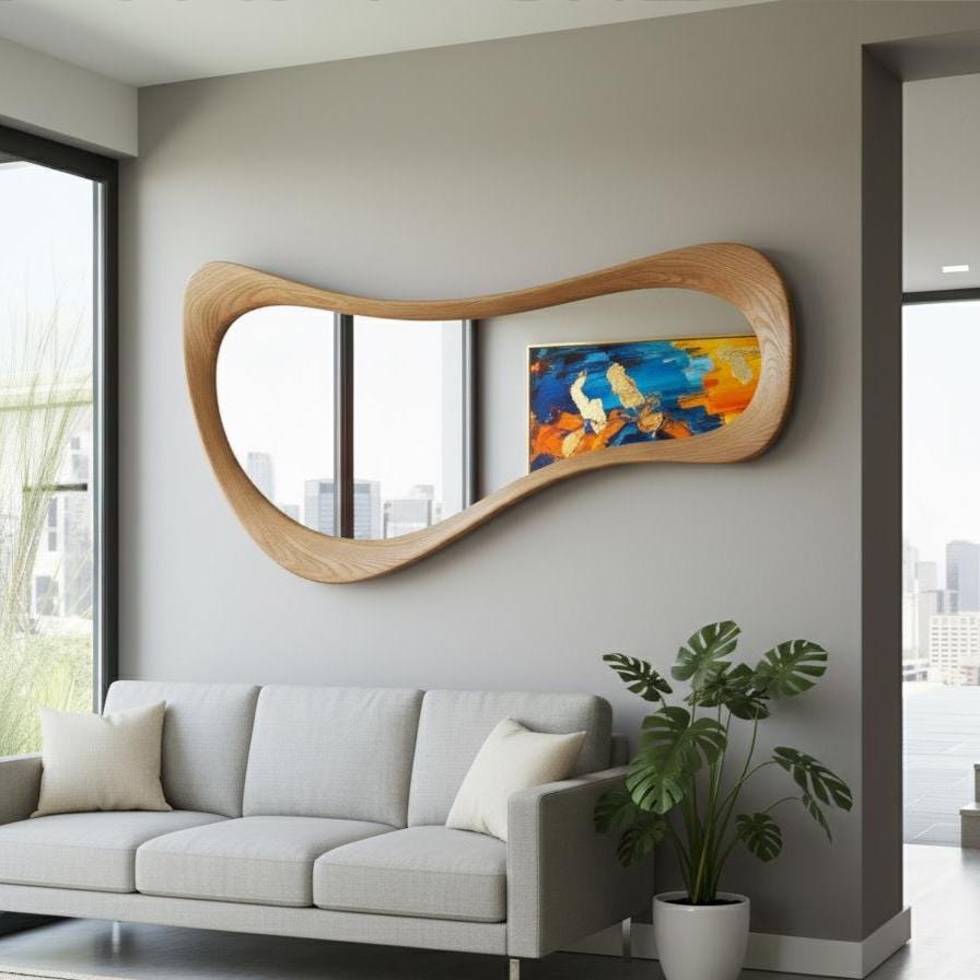May include: A large, modern, wooden mirror with a unique, flowing shape. The mirror is mounted on a gray wall above a gray sofa. An abstract painting with blue, yellow, and orange hues is visible in the mirror's reflection.