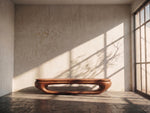 May include: A low, wooden bench with a curved design and a rich brown finish. The bench is the focal point of a sunlit room with a textured wall and a large window. The room's interior is minimalist and modern.