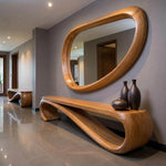 May include: A modern entryway featuring a large, oval-shaped wooden mirror and a matching bench with a unique, flowing design. The bench supports three dark brown vases. The floor is tiled, and the walls are painted a neutral gray.