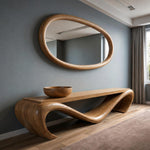 May include: A wooden oval mirror hangs above a matching console table. The table has a unique, flowing design with curved legs. A wooden bowl sits on the table's surface. The room has a modern, minimalist aesthetic.