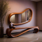 May include: A modern, wooden entryway set featuring a large, organically shaped mirror and a matching bench. The mirror and bench are a warm brown color. Two dark brown vases sit on the bench, and a tall plant is in a vase to the left.
