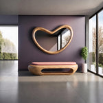 May include: A wooden bench with a smooth, light-colored wood grain base and a solid pink upholstered seat cushion, paired with a large, organic, heart-shaped wall mirror featuring a matching light-colored wooden frame.