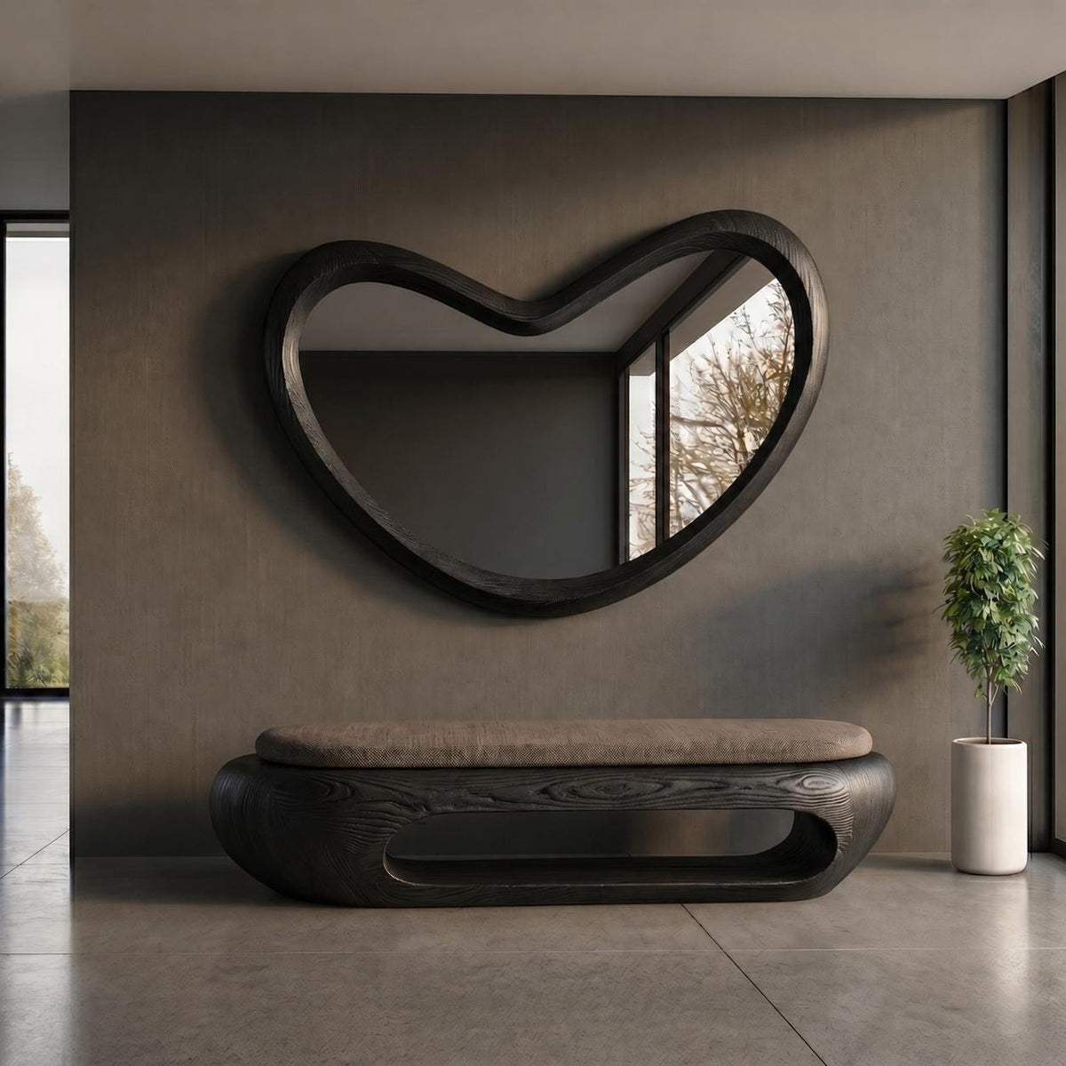 May include: A wall-mounted mirror with a dark wood frame in an irregular, organic heart-like shape, positioned above a low, elongated bench featuring a dark wood base with a central open cutout and a flat, neutral-toned upholstered seat cushion.